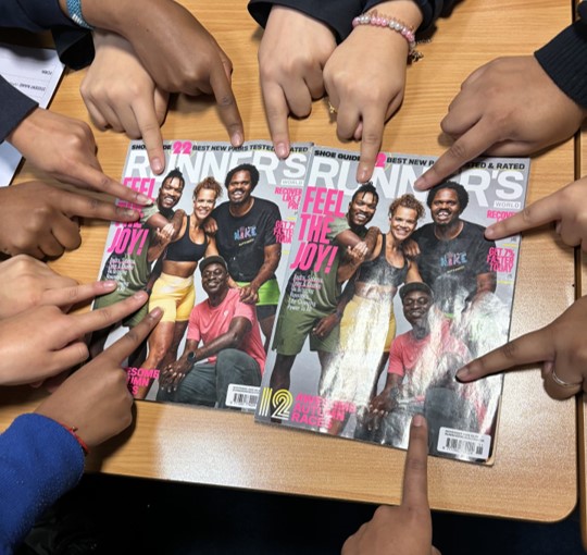 Students' fingers pointing out BAME runners on a magazine cover